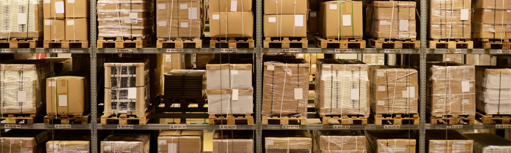 boxes stacked on top of a metal shelving system